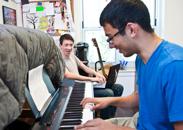 rooommates playing piano and studying