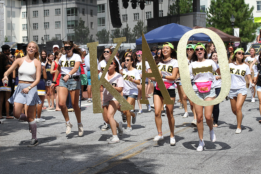 sorority students parade during homecoming