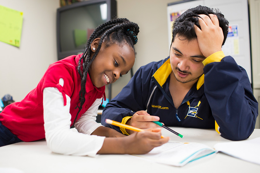 An Oxford student tutors a young girl