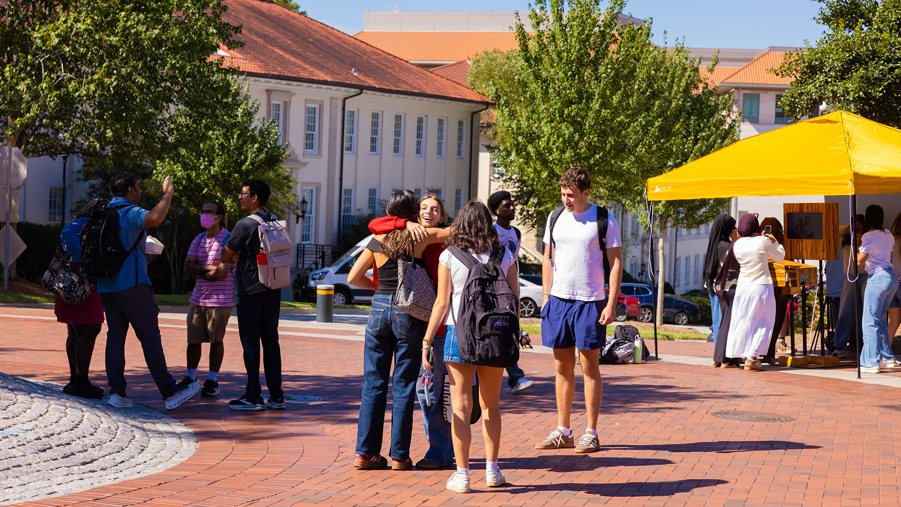 students greet each other on campus
