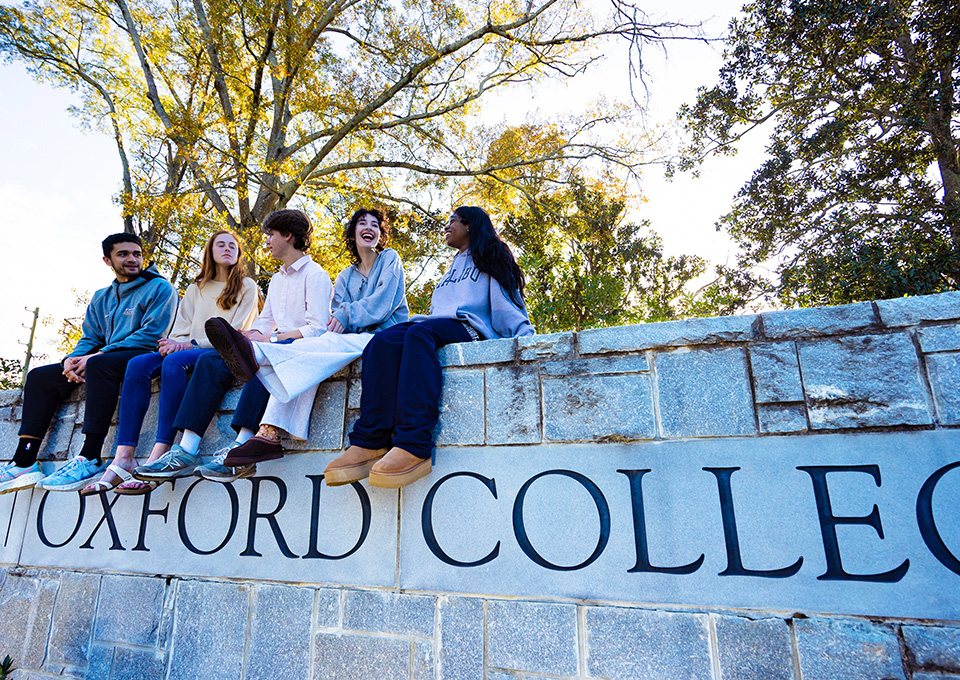 students sit on the wall at Oxford